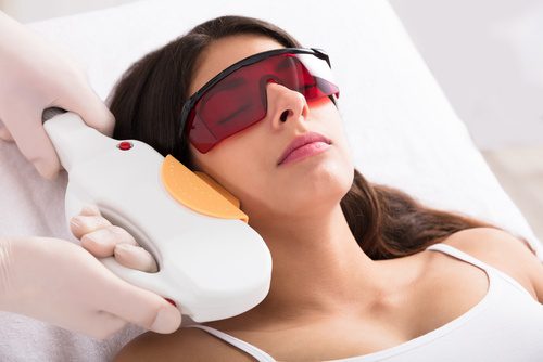 A Woman Receiving Laser Hair Removal of Neck